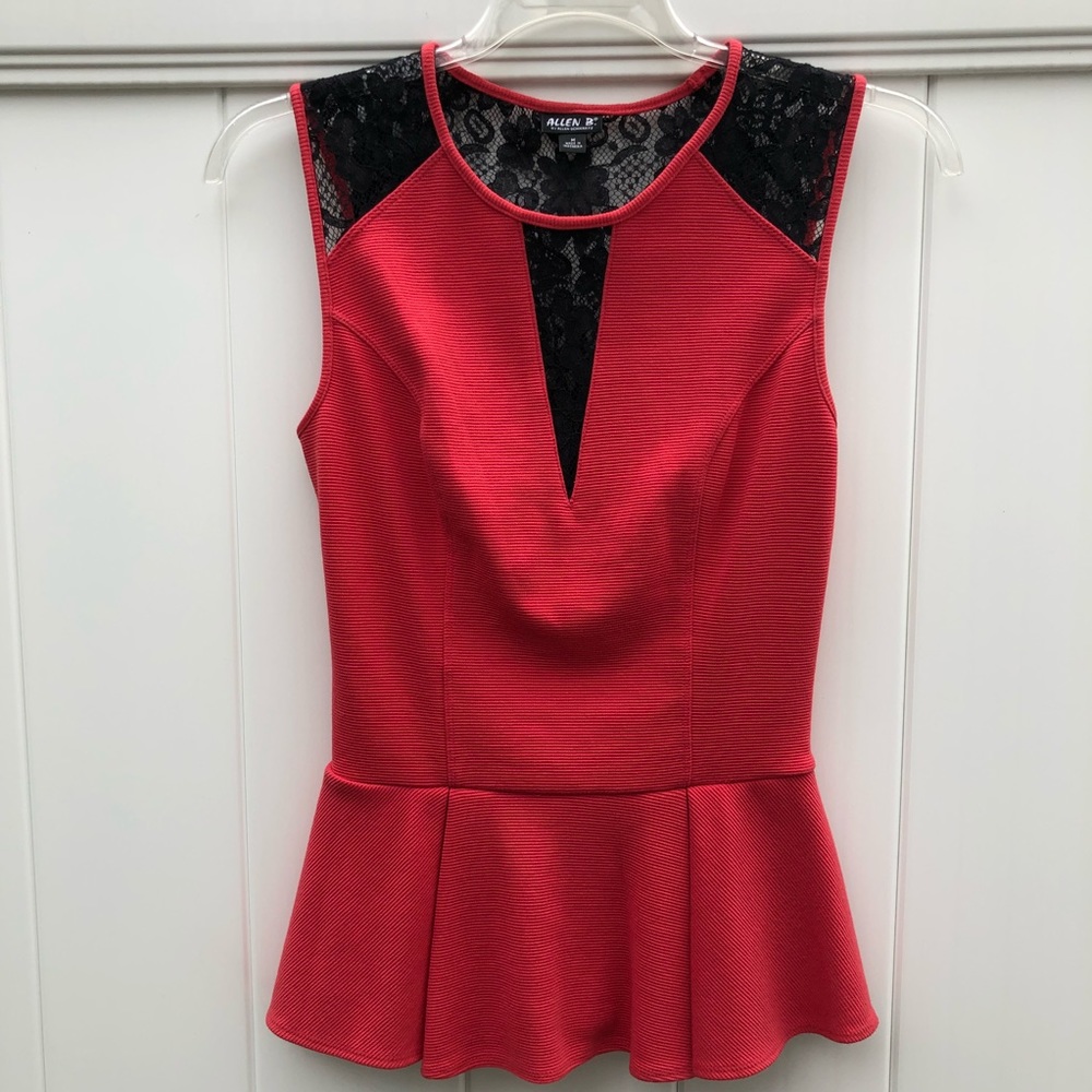 Pink peplum top with black lace cutouts